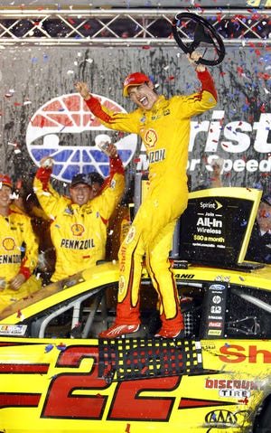 Joey Logano celabrates in Victory Lane after winning the NASCAR Sprint Cup Series auto race, Saturday, Aug. 22, 2015, in Bristol, Tenn. (AP Photo/Wade Payne)
