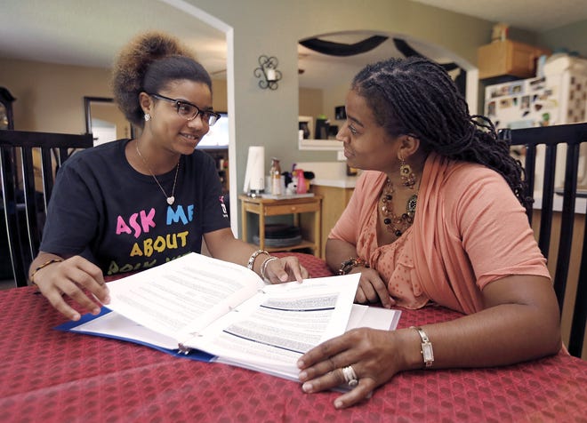 (L-R) Desiree Simons and her mom Angela Forte look over program material at home in Winter Haven. Desiree Simons, a senior at Winter Haven High, was recently selected as a member of The National Campaign to Prevent Teen and Unplanned Pregnancy´s Youth Leadership Team. She has been part of a local teen pregnancy prevention team for a few years.