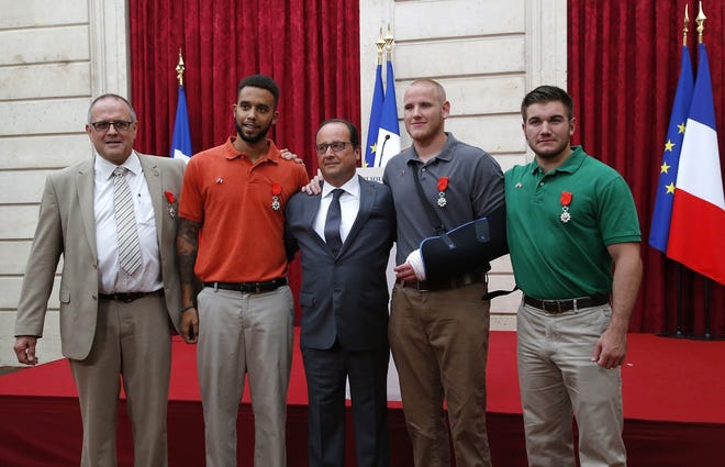 From the left, British businessman Chris Norman, Anthony Sadler, a senior at Sacramento University in California, French President Francois Hollande, U.S. Airman Spencer Stone, and Alek Skarlatos a U.S. National Guardsman from Roseburg, Oregon pose at the Elysee Palace, Monday Aug.24, 2015 in Paris, France. Hollande pinned the Legion of Honor medal on U.S. Airman Spencer Stone, National Guardsman Alek Skarlatos, and their years-long friend Anthony Sadler, who subdued the gunman as he moved through the train with an assault rifle strapped to his bare chest. The British businessman, Chris Norman, also jumped into the fray.