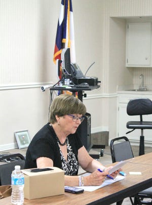 Dr. Ann Calahan, president of the SISD board of trustees, read the ordinance to set the tax rate at Monday's meeting.