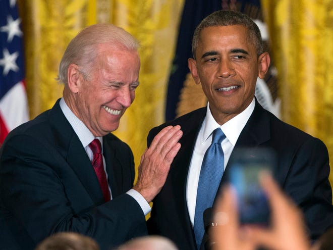 FILE - In this June 24, 2015 file photo Vice President Joe Biden and President Barack Obama speak in the East Room of the White House in Washington. President Barack Obama is the man in the middle as his vice president weighs challenging his former secretary of state for the 2016 Democratic nomination. While Obama would officially stay neutral in a Biden-Clinton face-off, the contest would essentially be a fight over which of his closest advisers is the rightful heir to his legacy.