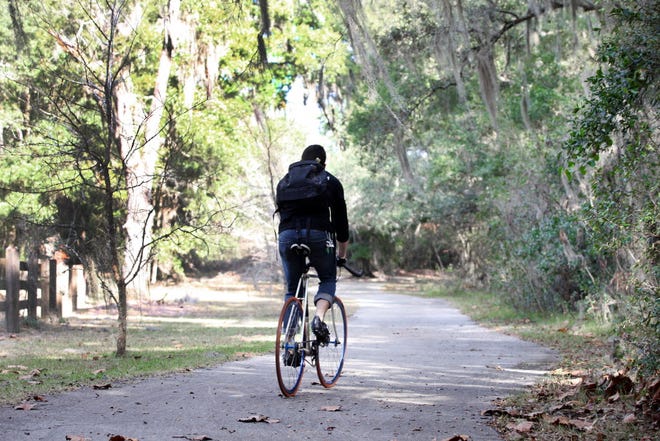 Alex Orlando rides his bike along the Gainesville-Hawthorne Head Trail.