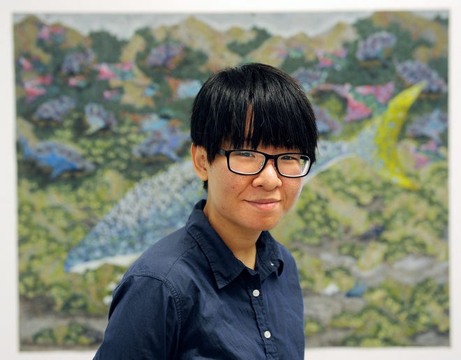 Contemporary Arts International artist-in-residence Chou Yu-Chen, a 21-year-old Taiwanese artist, stands for a photo in front of her favorite print, during her "Innovative Print Making" opening reception Aug. 23 at CAI.

Wicked Local Staff Photo/David Gordon