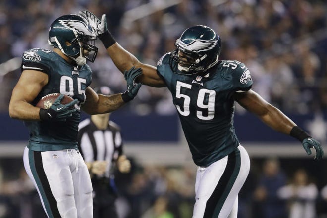Eagles inside linebacker Mychal Kendricks (95) is congratulated by teammate DeMeco Ryans (59) during a game last season.