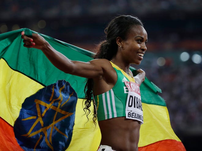 Ethiopia's Genzebe Dibaba celebrates after winning the womenâ€™s 1500m final at the World Athletics Championships at the Bird's Nest stadium in Beijing, Tuesday, Aug. 25, 2015.