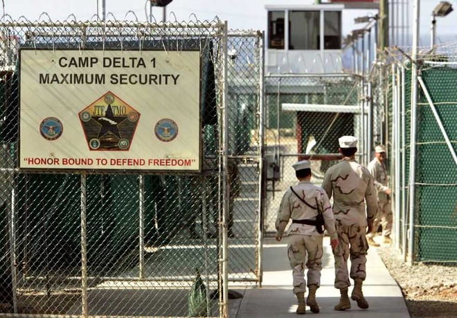 U.S. military guards walk within Camp Delta military-run prison, at the Guantanamo Bay U.S. Naval Base, Cuba.