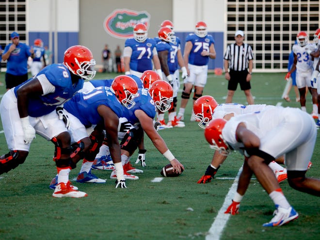 Florida’s offensive lineman go up against the defense during practice Tuesday at the Sanders complex.
