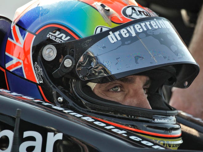 This March 25, 2011 file photo shows Justin Wilson, of England, preparing for a practice run for the Honda Grand Prix of St. Petersburg in St. Petersburg, Fla. Wilson has died from a head injury suffered when a piece of debris struck him at Pocono Raceway. He was 37.