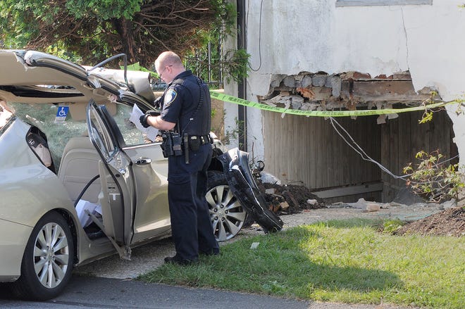 (FILE PHOTO) A Warrington Township police officer investigates the scene of a vehicle crash that went into the basement of a house Friday, August 21, 2015, at 1380 Easton Road in Warrington.
