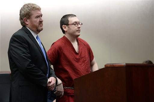 Colorado theater shooter James Holmes appears in court, with his attorney Daniel King, to be formally sentenced, Wednesday, Aug. 26, 2015 in Centennial, Colo. Holmes was sentenced to life in prison without parole by Judge Carlos Samour Jr. Holmes killed 12 people and injured 70 others in the July 20, 2012 ambush. (RJ Sangosti/The Denver Post via AP, Pool)