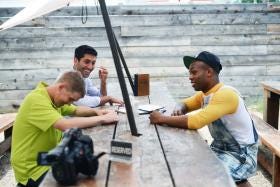 "Catfish: The TV Show" host Nev Schulman, back, and guest host Todrick Hall, right, talk with Canyon resident Devan about an online relationship during the filming of an episode in Canyon.