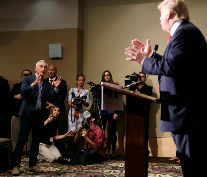 Miami-based Univision anchor Jorge Ramos, left, asks Republican presidential candidate Donald Trump a question about his immigration proposal during a news conference Tuesday in Dubuque, Iowa. Ramos was later removed from the room.