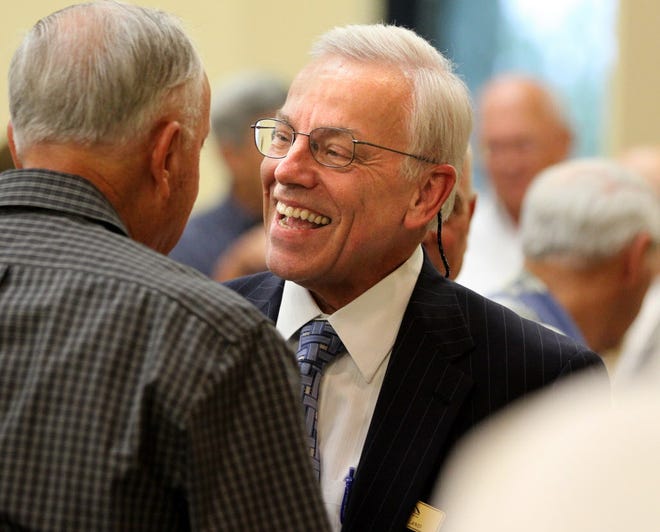 Lakeland attorney John K. Vreeland chats with friends. Vreeland resigned from a trust he oversaw, one day after a lawsuit was filed against him.
