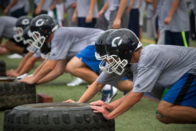 Cohasset High School football players participate in a drill during the first day of practice Monday, Aug. 24, 2015.