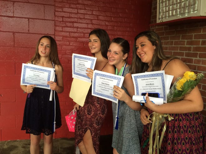 Erin Rego, Madelyn Claffey, Tessa Palermo and Jenna Moore receive certificates for moving on from Belmonte Middle School. Courtesy photo