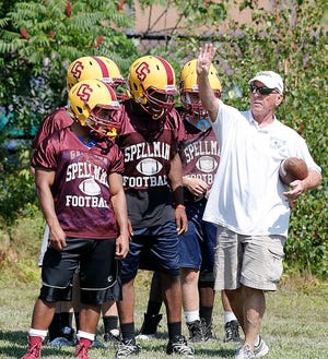 Assistant coach Ralph Goslin works with the running backs during Cardinal Spellman High football practice on Wednesday, Aug. 26, 2015.