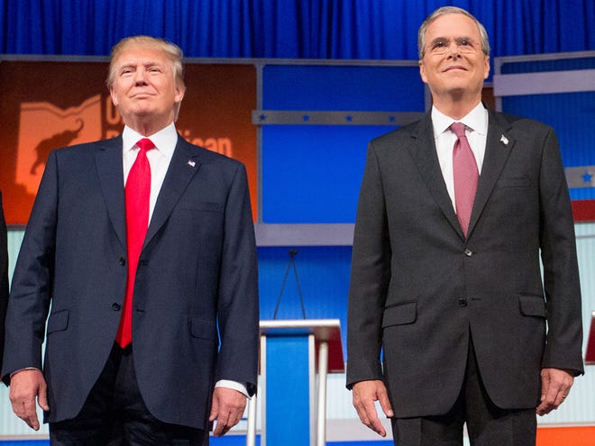 In this photo taken Aug. 6, Republican presidential candidates Donald Trump and former Florida Gov. Jeb Bush take the stage for the first Republican presidential debate at the Quicken Loans Arena in Cleveland.