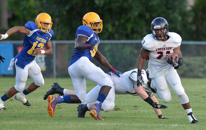 PETER.WILLOTT@STAUGUSTINE.COM Creekside High School's Blake Morgan runs the ball to score a touchdown in his school's spring football game against Palatka High School on Thursday, May 21, 2015 in Palatka.