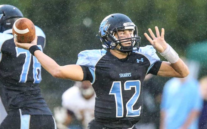 GARY MCCULLOUGH/CORRESPONDENT Ponte Vedra's Nick Tronti (12) passes the ball in the rain against St. Augustine during the first half of high school football action at Ponte Vedra High School in Ponte Vedra, Fla., Friday, September 26, 2014.