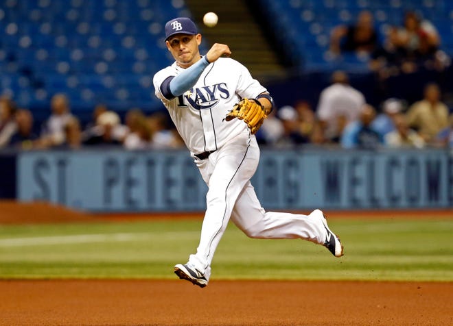Tampa Bay Rays shortstop Asdrubal Cabrera throws errantly to first base, allowing Minnesota Twins' Kurt Suzuki to score during the fourth inning of a baseball game Thursday, Aug. 27, 2015, in St. Petersburg, Fla.
