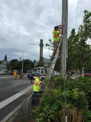 Cape Cod Commission workers install a temporary Bluetoad system to monitor traffic in Provincetown in mid-August. Photo Peter J. Brown