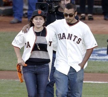 FILE - This Oct. 26, 2014, file photo shows Robin William's children Zelda, left, and Cody, walking out to the pitcher's mound before Game 5 of baseball's World Series in San Francisco. (AP Photo/Charlie Riedel, File)