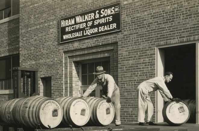 Workers roll barrels of whiskey at the Hiram Walker plant in Peoria.