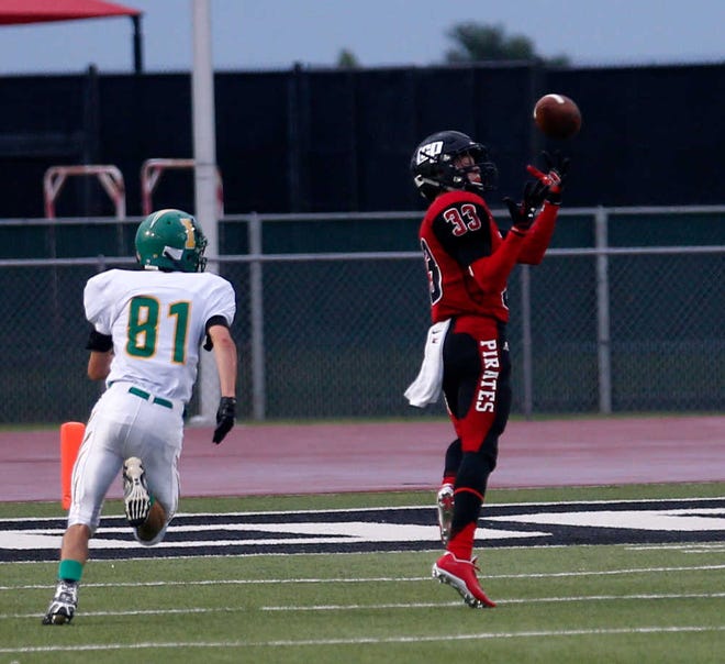 Idalou (81) Dillon Binder looks on as Cooper (33) Zach Smith hauls in a first quarter touchdown catch. Lubbock Cooper played Idalou at Cooper Friday, August 28, 2015. (Mark Rogers/AJ Media)