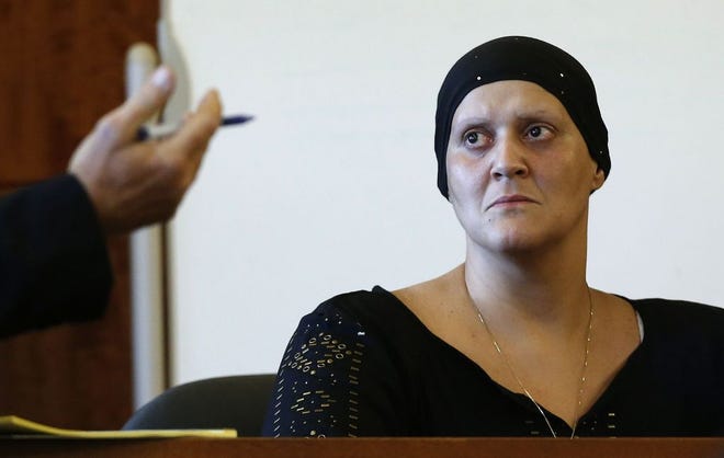 Tanya Singleton sits on the witness stand during a hearing in Bristol County Superior Court in Fall River in June 2014. Prosecutors have dropped her remaining criminal charges on account of her treatment for breast cancer.