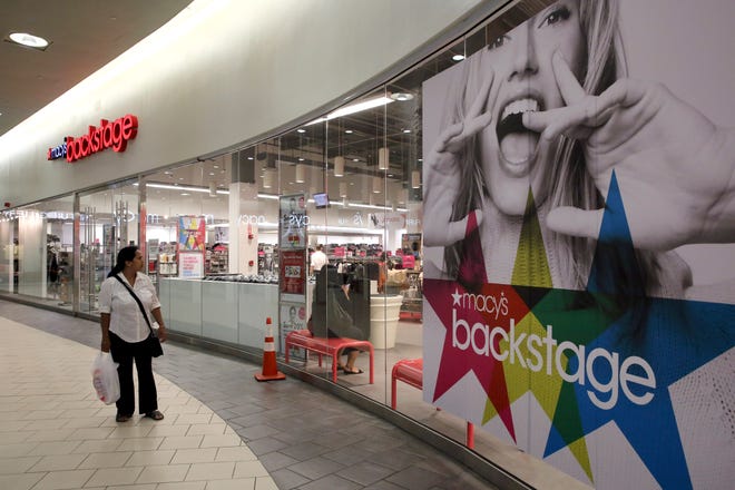 A shopper walks past the Macy's Backstage store in Queens, New York, on Wednesday. Macy’s decision to jump into the off-price game comes as the department store retailer faces a sales slowdown.