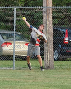 Dragon 88 left fielder Ryan O'Connell makes a throw at the fence. BANNER PHOTO/GRAHAM ENTWISTLE