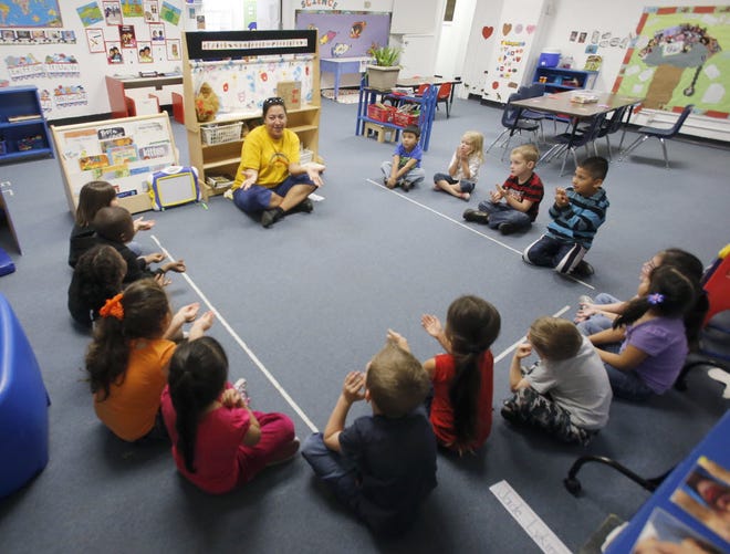A teacher leads a sign language lesson during a voluntary prekindergarten class in Fort Meade.