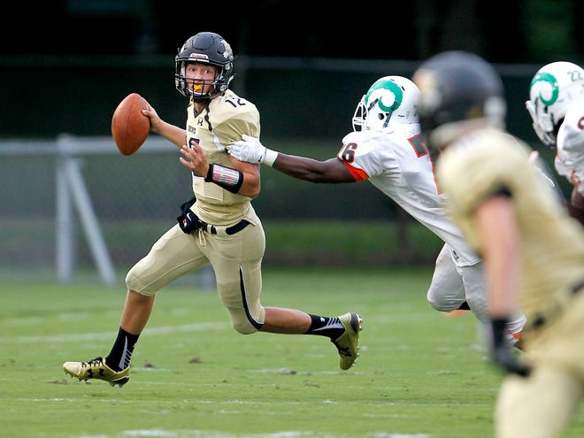 Buchholz Bobcats quarterback Jackson White looks to throw against the Eastside Rams during the first game of the season. The Bobcats won 48-13 behind White's four touchdown passes.