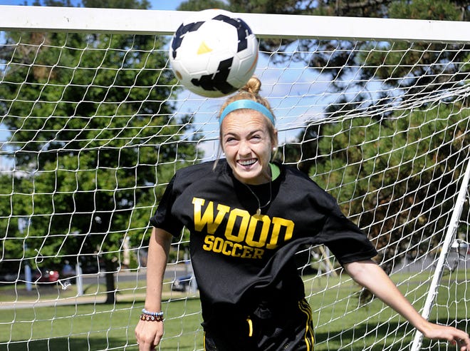 Opposing players trying to line up a good shot at the Archbishop Wood goal will have to find a way to beat defender Clair Bassetti. The senior, who directs traffic for the backliners, is shown working on heading the ball away during a preseason practice.