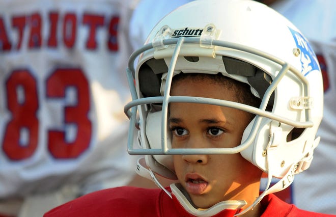 Carmello Anderson, 7, looks out onto the field before he plays his first football game ever Saturday at the Westamtpon Sports Complex.