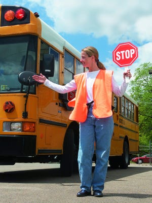 Parents can teach their children the signals used by crossing guards to ready them for school. Metro Photo