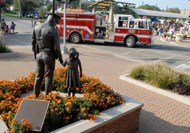 In the foreground is the statue titled "The Protector" which stands in front of the Holland Police Department building. Sentinel file