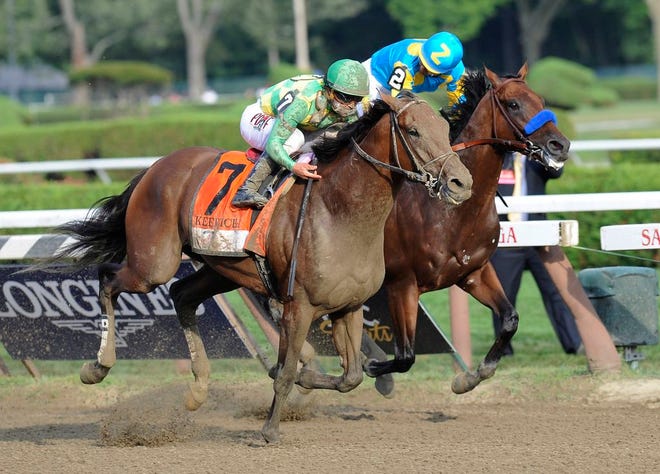 Keen Ice (7), with Javier Castellano, moves past Triple Crown winner American Pharoah, with Victor Espinoza, to win the Travers Stakes horse race at Saratoga Race Course in Saratoga Springs, N.Y., Saturday, Aug. 29, 2015. (AP Photo/Hans Pennink)
