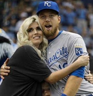 The Royals' Ben Zobrist hugs his wife, Julianna, on Friday during a video tribute before the Rays played the Royals in St. Petersburg. Zobrist played nine season for the Rays. Holding on to Zobrist is his son, Zion.