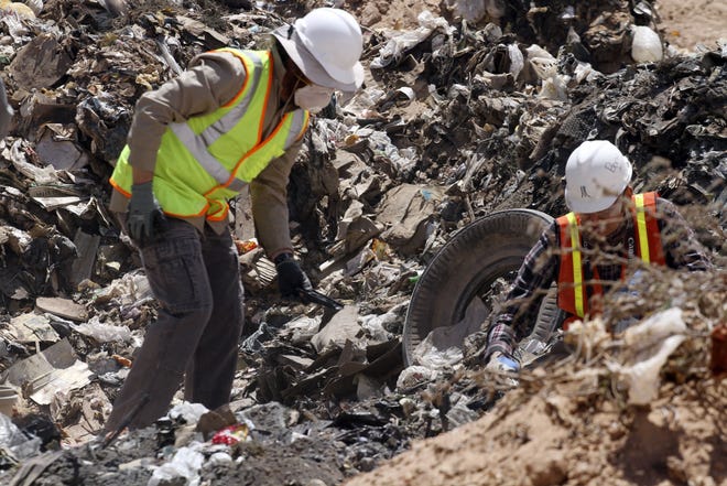 In this April 26, 2014, file photo, workers sift through trash in search for decades-old Atari 'E.T. the Extra-Terrestrial' game cartridges in Alamogordo, New Mexico. The Associated Press