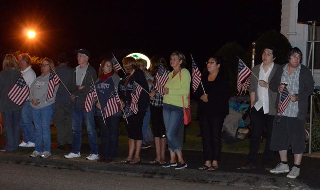 Several hundred people lined the street in front of the funeral home to greet the body of a retired Colonel Richard McEvoy killed in Afghanistan. T&G Staff/Kim Ring