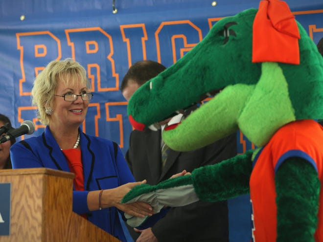 Florida Lottery secretary Cynthia F. O'Connell greets Alberta before her speech during the Florida Lottery and University of Florida event in the North Lawn outside the Reitz Union on September 18, 2014, in Gainesville, Fla.
