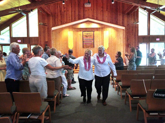 Together for 42 years, Orange Springs residents MJ Eckford, left, and Roberta Pedersen, right, get married to each other in front of friends and family at the United Church of Gainesville, Saturday, August 22, 2015 in Gainesville, Fla.