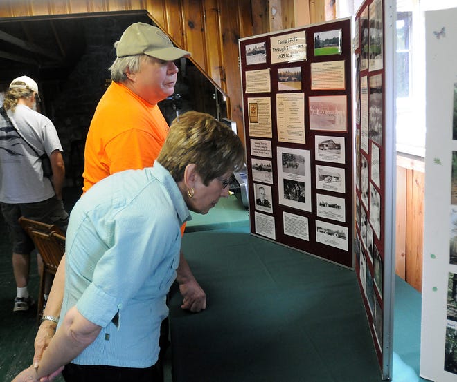 Bob Nordstrom and his wife, Sheril, of Uxbridge, look over a display of the Civilian Conservation Corps at the Upton State Forest, Saturday in Upton. Daily News Staff Photo/ John Thornton