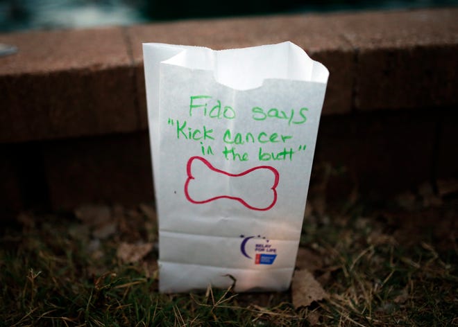 A message from Fido on a luminaria provides inspiration during the American Cancer Society's "Bark For Life, The Night to Remember" at Hafer Park in Edmond. [PHOTO BY SARAH PHIPPS, THE OKLAHOMAN]