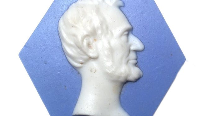 This Abraham Lincoln paperweight is rendered in glazed stoneware that resembles Wedgwood’s Jasperware.