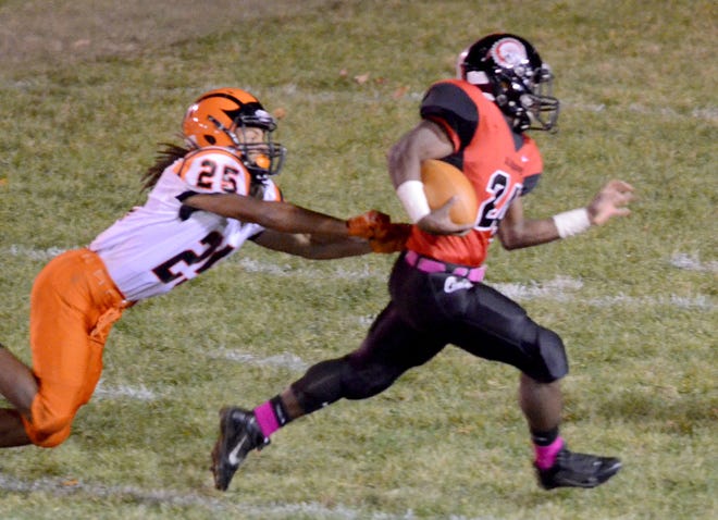 Aliquippa's Dimontae Bronaugh runs for a touchdown as Beaver Falls' Derrell Carter tries to stop him during the Quips' 56-6 victory over Beaver Falls on Friday, Oct. 24, 2014.
