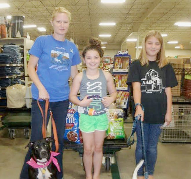 Norah VanWagner (center) recently celebrated her birthday by collecting donations of supplies for the foster animals of Animal Aid of Branch County. Pictured with Norah are Kalyn and Ivy Parnell and Darla, a foster of the AABC. Courtesy Photo