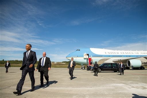 President Barack Obama walks to greet visitors after arriving at Elmendorf Air Force Base, Monday, Aug. 31, 2015, in Anchorage, Alaska. Obama opens a historic three-day trip to Alaska aimed at showing solidarity with a state often overlooked by Washington, while using its glorious but changing landscape as an urgent call to action on climate change. (AP Photo/Andrew Harnik)