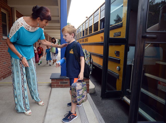 Principal Susan Klimpl (left) greets students as they arrive at Linden Elementary School Monday August 31, 2015 in Doylestown, Pennsylvania. It was the first day of school in the Central Bucks School District. (Photo by William Thomas Cain)